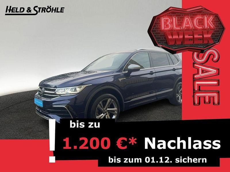 Atlantic blue metallic (metallic) Gebraucht 2024 VW Tiguan Allspace R-line SUV | 44.430 € (Etwas zu teuer) - Bild 1/2
