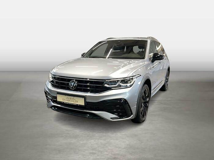 Pyritsilber (metallic) Gebraucht 2024 VW Tiguan Allspace R-line SUV | 60.320 € - Bild 1/4