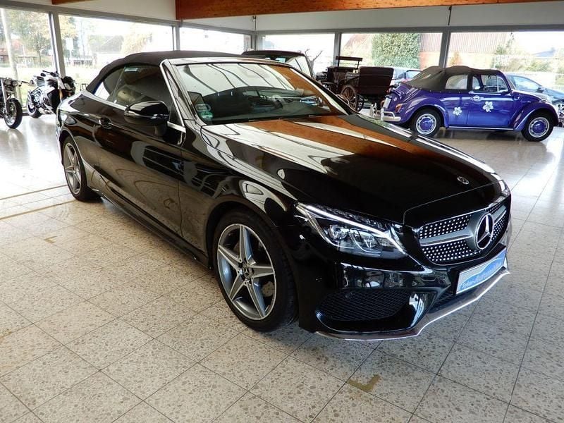 Obsidianschwarz metallic (metallic) Gebraucht 2018 Mercedes C180 AMG Cabrio | 23.950 € (Fairer Preis) - Bild 1/4