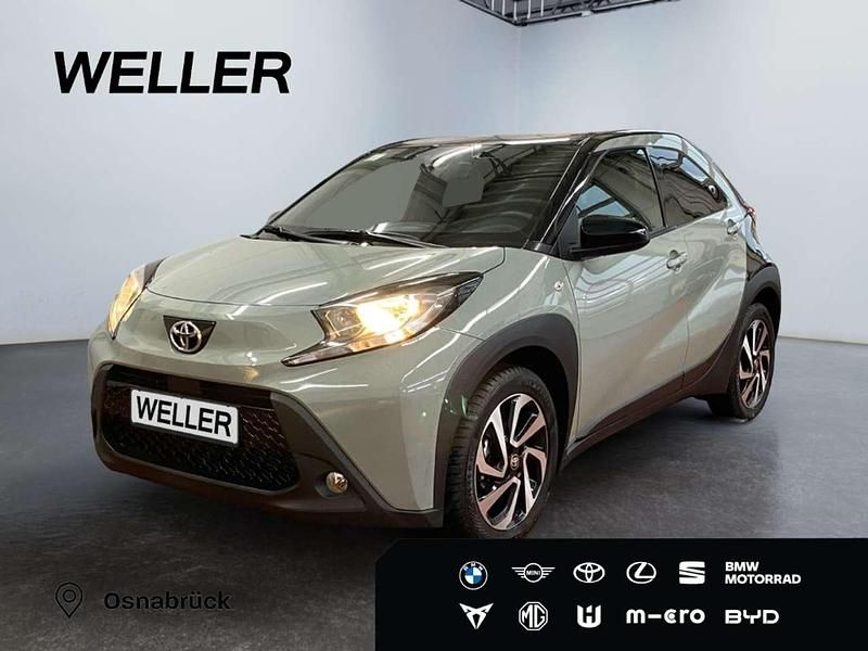 Grün Gebraucht 2024 Toyota Aygo X Team SUV | 15.450 € (Guter Preis) - Bild 1/3