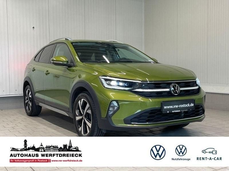 Visual green metallic (metallic) Gebraucht 2023 VW Taigo Style SUV | 22.389 € (Fairer Preis) - Bild 1/4