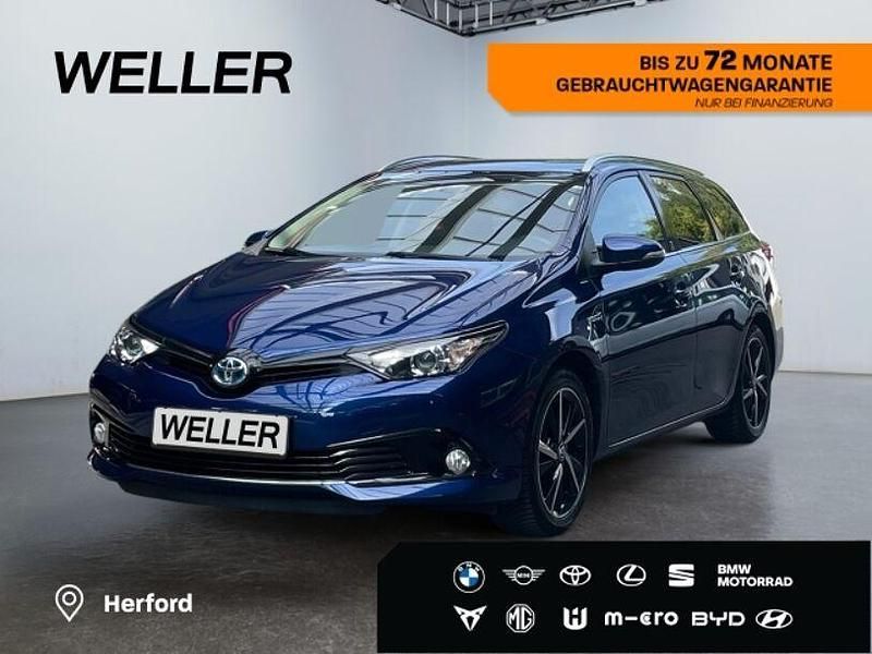 Oxygenblau mica Gebraucht 2018 Toyota Auris Hybrid Basis Kombi | 16.980 € (Fairer Preis) - Bild 1/4