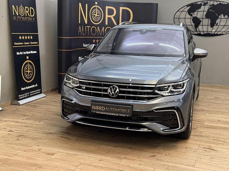 Platinum grey metallic (metallic) Gebraucht 2022 VW Tiguan Allspace R-line SUV | 33.899 € (Fairer Preis) - Bild 1/3