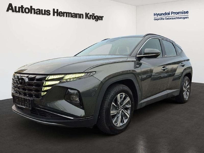 Amazon grey / met Gebraucht 2021 Hyundai Tucson Select SUV | 21.590 € (Superpreis) - Bild 1/4