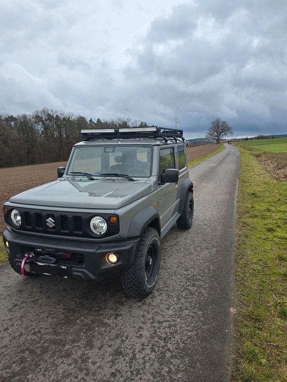 Grau Gebraucht 2023 Suzuki Jimny SUV | 32.900 € (Fairer Preis) - Bild 1/4