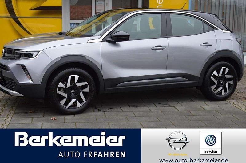 Gebraucht Opel Mokka-e Elegance 100 kW (136 PS) 2022 Kontrast grauquarz silber (metallic) SUV
