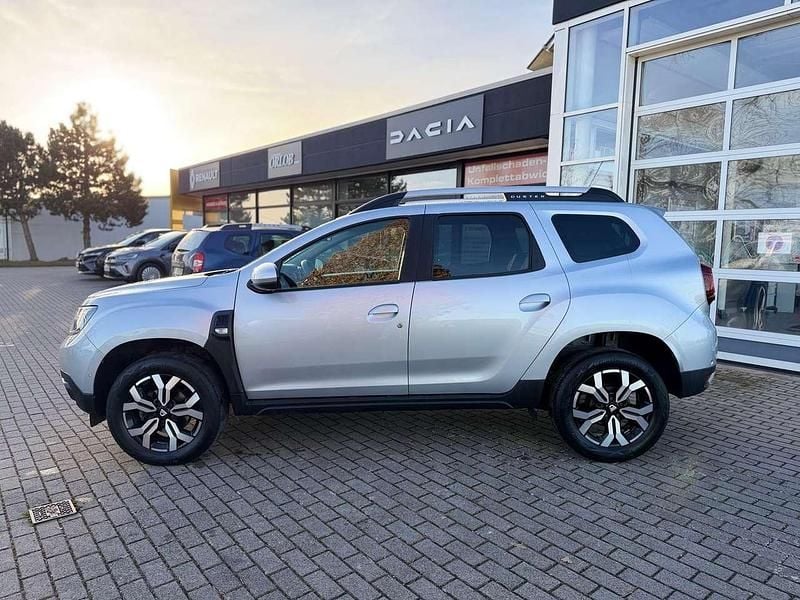 Kqa highlandgraumetallic Gebraucht 2021 Dacia Duster Prestige SUV | 14.990 € (Fairer Preis) - Bild 1/4