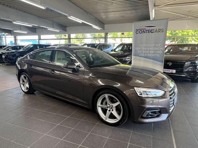 Argusbraun (metallic) Gebraucht 2019 Audi A5 Sport Coupé | 27.999 € (Fairer Preis) - Bild 1/4