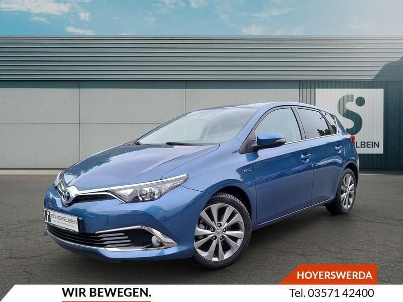 Denimblau metallic Gebraucht 2016 Toyota Auris Hybrid Basis Limousine | 15.900 € (Fairer Preis) - Bild 1/2