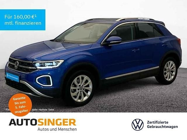 Ravennablau metallic Gebraucht 2024 VW T-Roc Style SUV | 32.960 € (Fairer Preis) - Bild 1/3