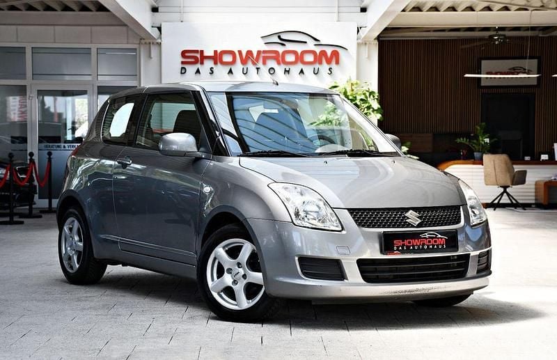 Grau ($2) Gebraucht 2010 Suzuki Swift Comfort Kleinwagen | 3.490 € (Fairer Preis) - Bild 1/4
