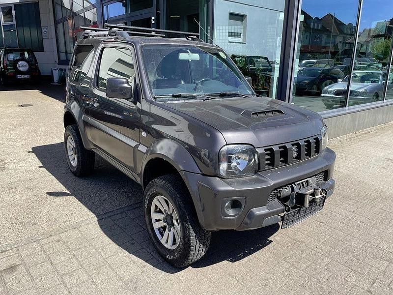 Grau Gebraucht 2012 Suzuki Jimny Style SUV | 11.500 € - Bild 1/4