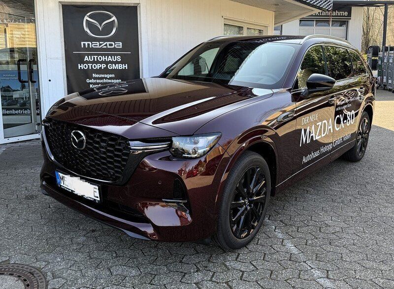 Artisan red metallic Gebraucht 2024 Mazda CX-80 Homura-Line SUV | 54.595 € (Etwas zu teuer) - Bild 1/4