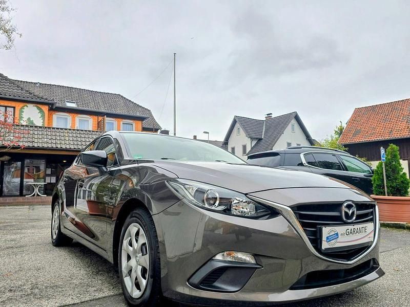 Titanium flash Gebraucht 2015 Mazda 3 Prime-Line Limousine | 9.900 € (Fairer Preis) - Bild 1/4