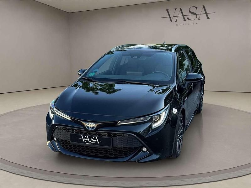 Black mica / ink Gebraucht 2019 Toyota Corolla Hybrid Club Kombi | 26.000 € - Bild 1/4