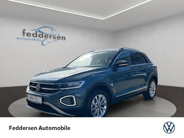 Petroleum blue metallic schwarz (metallic) Gebraucht 2024 VW T-Roc Style SUV | 29.588 € (Fairer Preis) - Bild 1/4