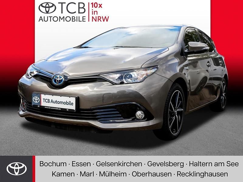 Platinum bronze metallic Gebraucht 2018 Toyota Auris Hybrid Basis Limousine | 17.489 € (Fairer Preis) - Bild 1/4