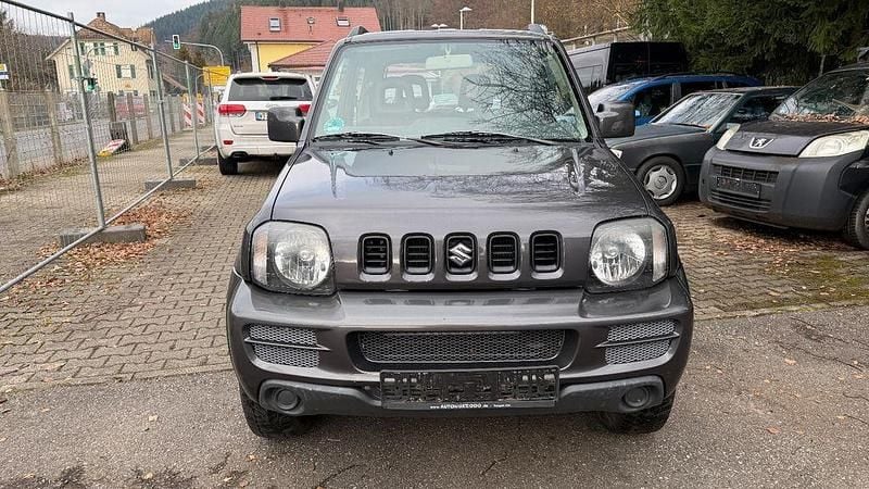 Grau Gebraucht 2012 Suzuki Jimny Club SUV | 4.800 € (Superpreis) - Bild 1/4