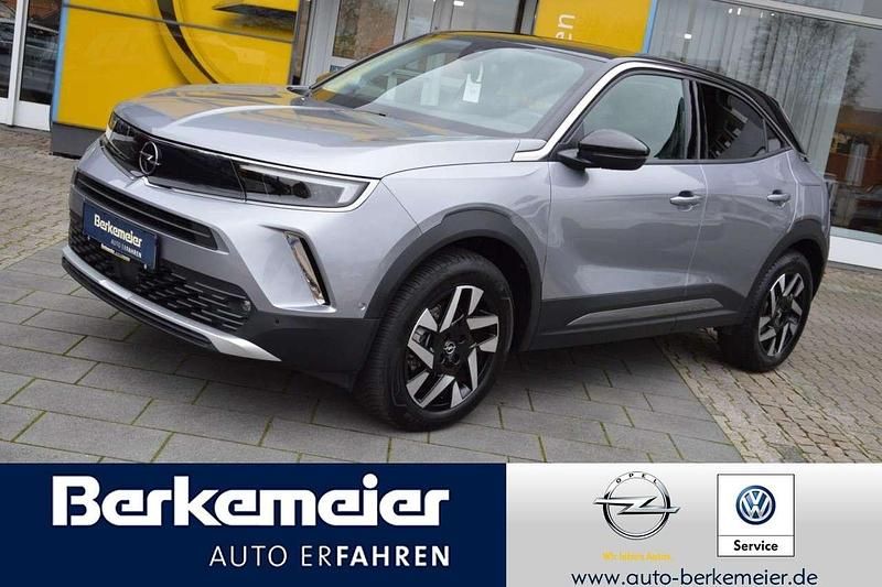 Gebraucht Opel Mokka-e Elegance 100 kW (136 PS) 2022 Kontrast grauquarz silber (metallic) SUV