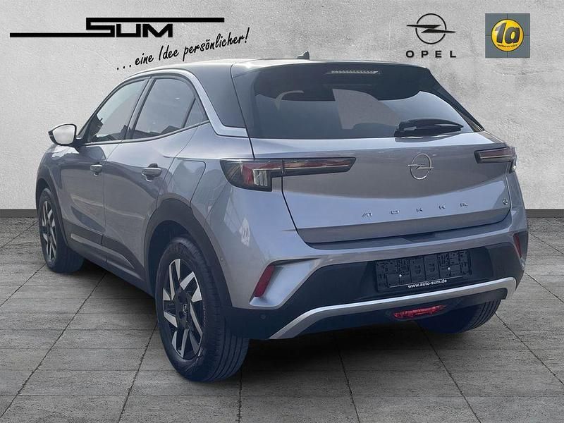 Gebraucht Opel Mokka-e Elegance 100 kW (136 PS) 2023 Kontrast grau/quarz silber SUV