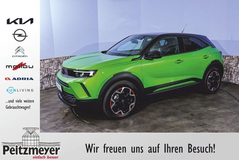 Ikone grün metallic Gebraucht 2023 Opel Mokka-e SUV | 33.333 € - Bild 1/4