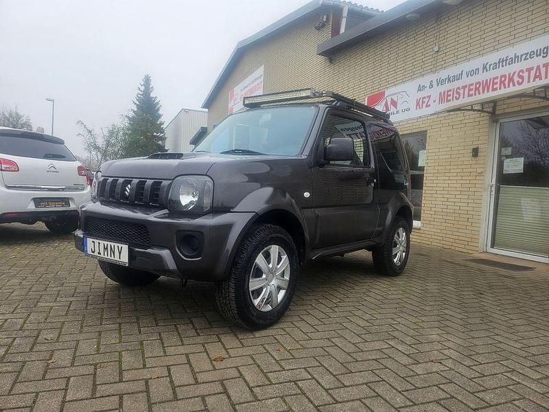 Grau Gebraucht 2013 Suzuki Jimny Comfort SUV | 11.490 € (Fairer Preis) - Bild 1/4