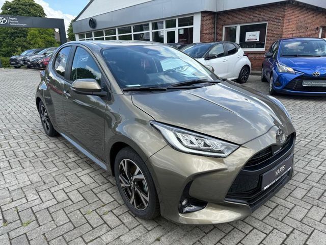 Bronze metallic Neu 2025 Toyota Yaris Hybrid Team Kleinwagen | 25.990 € (Fairer Preis) - Bild 1/4