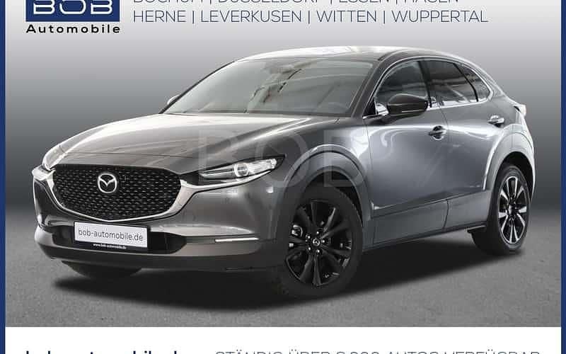 Machine gray (grau) (grau) Gebraucht 2024 Mazda CX-30 Homura-Line SUV | 27.870 € (Fairer Preis) - Bild 1/4