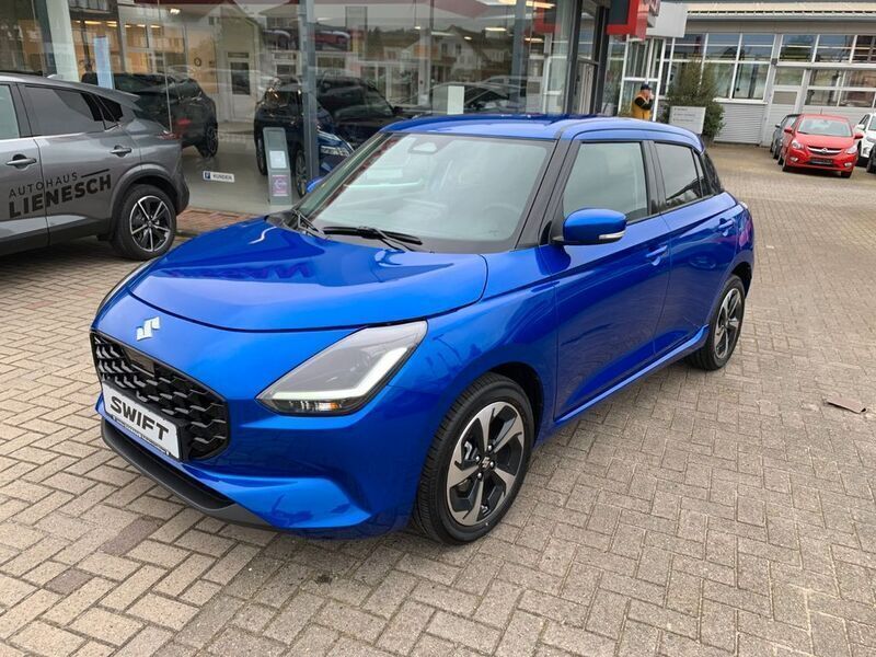 Blau Neu 2024 Suzuki Swift Comfort+ Limousine | 23.395 € - Bild 1/4