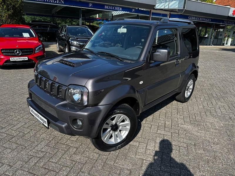 Grau Gebraucht 2013 Suzuki Jimny Style SUV | 15.490 € (Teuer) - Bild 1/4