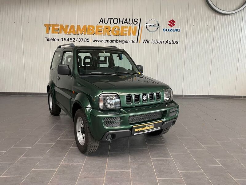 Gruen (metallic) Gebraucht 2011 Suzuki Jimny Comfort SUV | 9.900 € - Bild 1/4