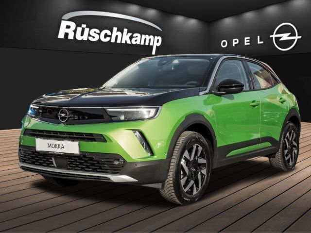 Matcha green/metalliclackierung (metallic) Gebraucht 2023 Opel Mokka-e Elegance SUV | 22.880 € (Fairer Preis) - Bild 1/4