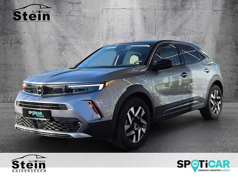 Gebraucht Opel Mokka-e Elegance 100 kW (136 PS) 2022 Kontrast grau/quarz silber (metallic) SUV
