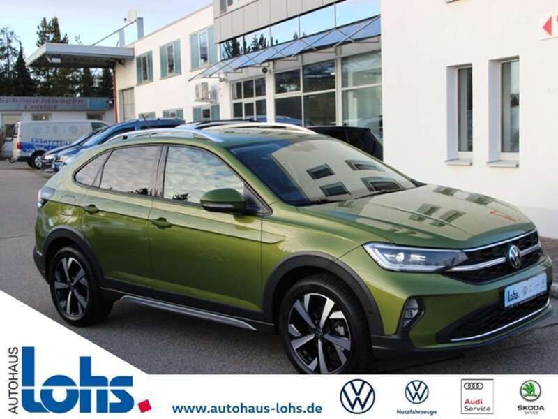 Grün (visual green metallic) Gebraucht 2024 VW Taigo Style SUV | 27.767 € (Fairer Preis) - Bild 1/4
