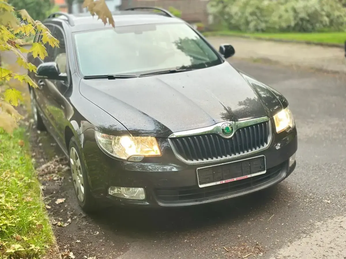 Używany Skoda Superb 125 KM (91 kW) 2013 Czarny Kombi