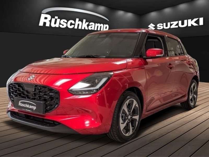 Burning red pearl metallic Neu 2025 Suzuki Swift Comfort+ Kleinwagen | 19.680 € - Bild 1/4