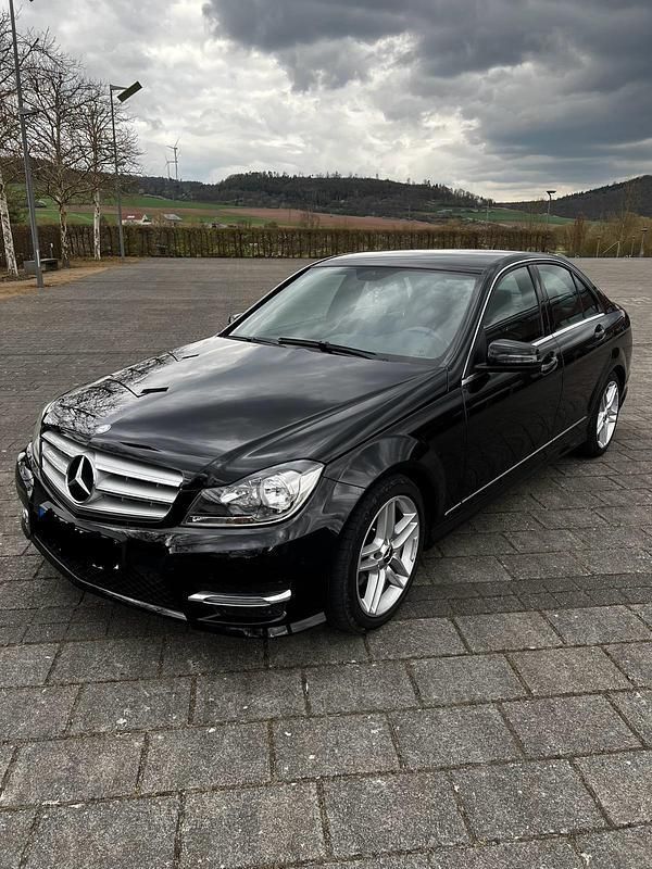Schwarz Gebraucht 2013 Mercedes C180 AMG line Limousine | 12.700 € - Bild 1/4
