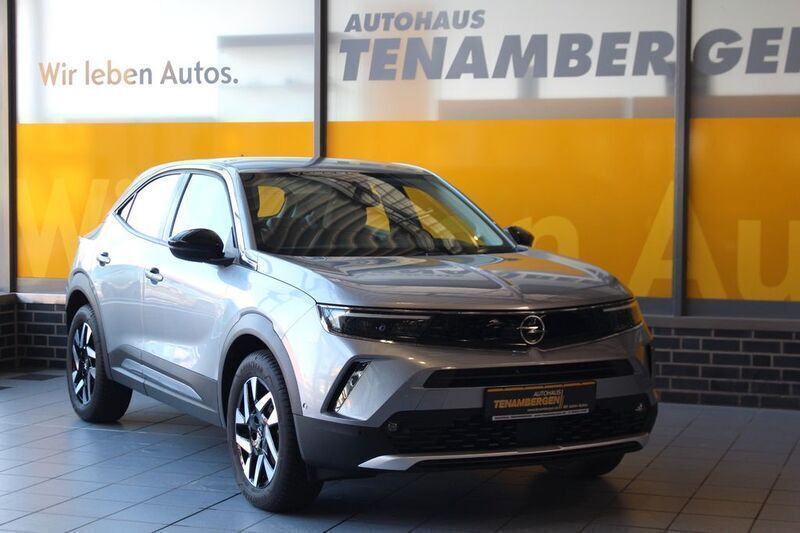 Gebraucht Opel Mokka-e Elegance 100 kW (136 PS) 2023 Kontrast grau/quarz silber SUV