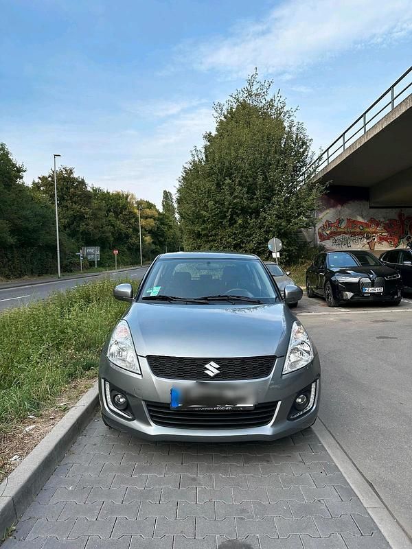 Grau Gebraucht 2015 Suzuki Swift Comfort Kleinwagen | 6.500 € (Fairer Preis) - Bild 1/4