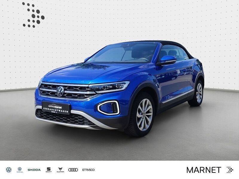 Ravennablau metallic/schwarz Gebraucht 2023 VW T-Roc Cabriolet Style Cabrio | 26.990 € (Superpreis) - Bild 1/4