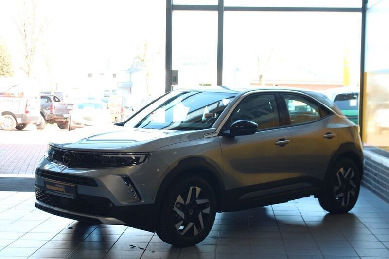 Gebraucht Opel Mokka-e Elegance 100 kW (136 PS) 2023 Kontrast grau/quarz silber SUV