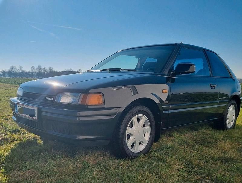 Schwarz Gebraucht 1990 Mazda 323 Kleinwagen | 14.990 € - Bild 1/4