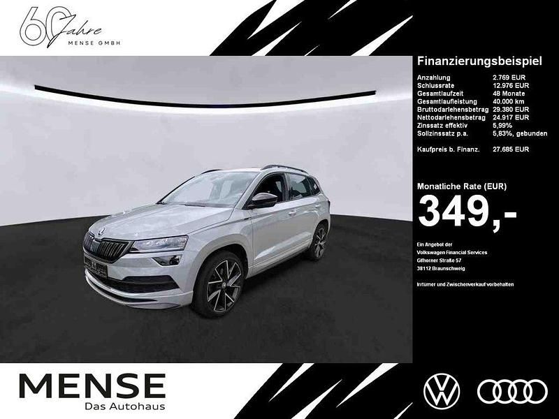 Steelgrau Gebraucht 2022 Skoda Karoq SportLine SUV | 27.685 € (Teuer) - Bild 1/4