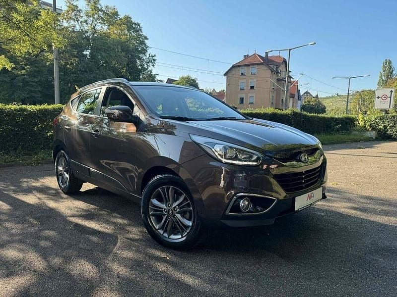 Braun Gebraucht 2014 Hyundai Tucson Trend SUV | 14.900 € - Bild 1/4