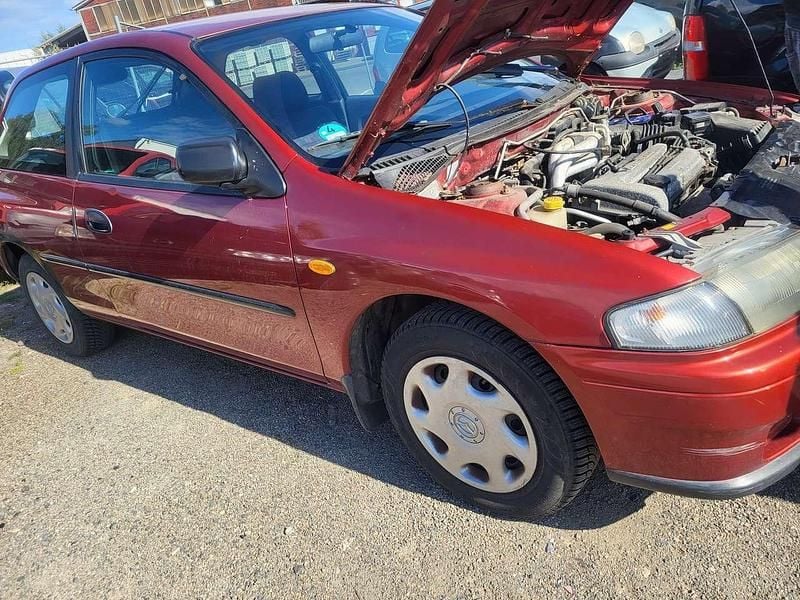 Braun Gebraucht 1997 Mazda 323 Limousine | 900 € (Fairer Preis) - Bild 1/4