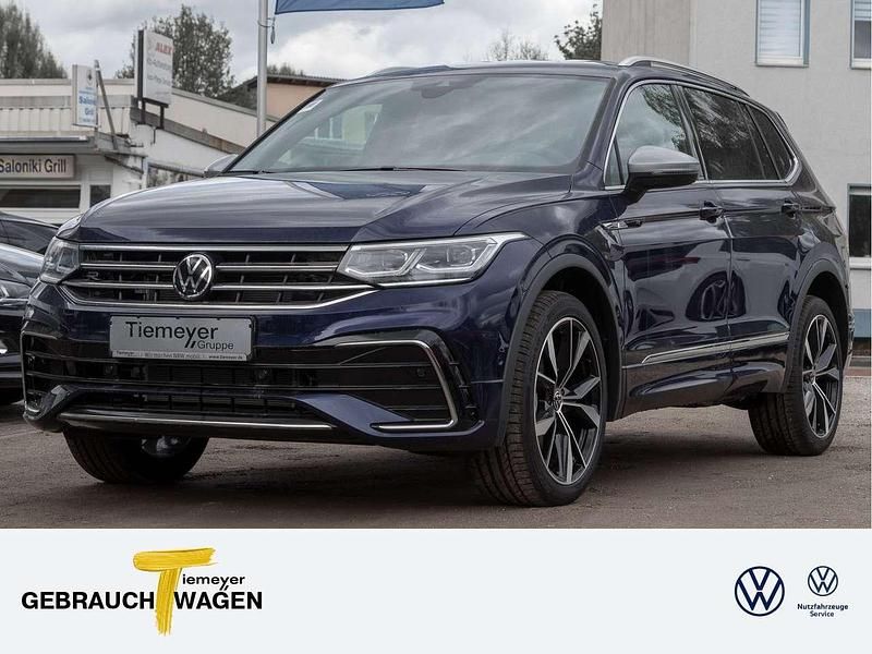 Atlantic blue metallic Gebraucht 2024 VW Tiguan Allspace R-line SUV | 42.920 € (Fairer Preis) - Bild 1/4