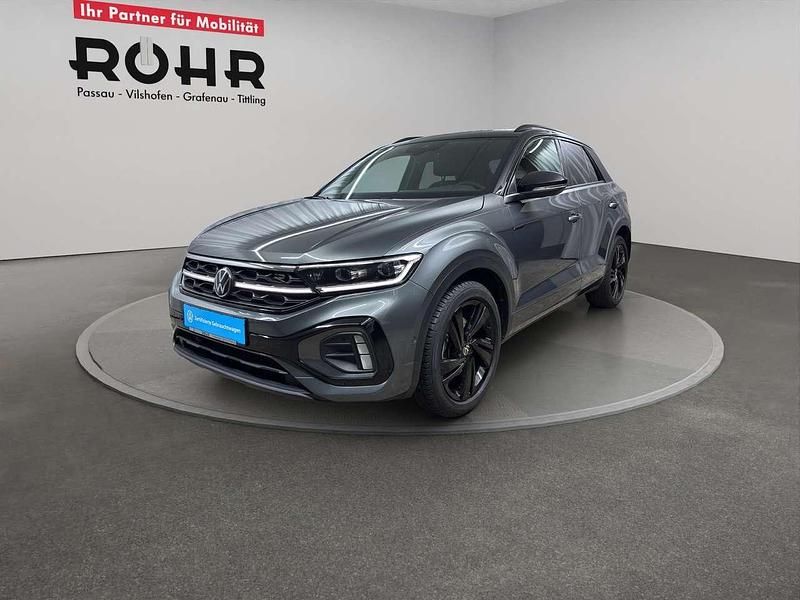Indiumgrau metallic / schwarz Gebraucht 2024 VW T-Roc R-line SUV | 33.980 € (Teuer) - Bild 1/4