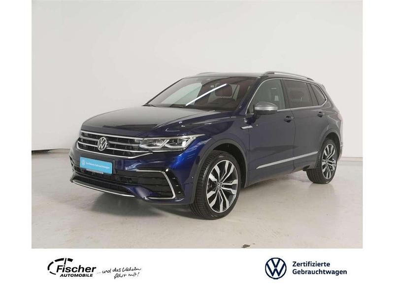 Atlanticblue metallic Gebraucht 2024 VW Tiguan Allspace R-line SUV | 46.940 € (Etwas zu teuer) - Bild 1/3