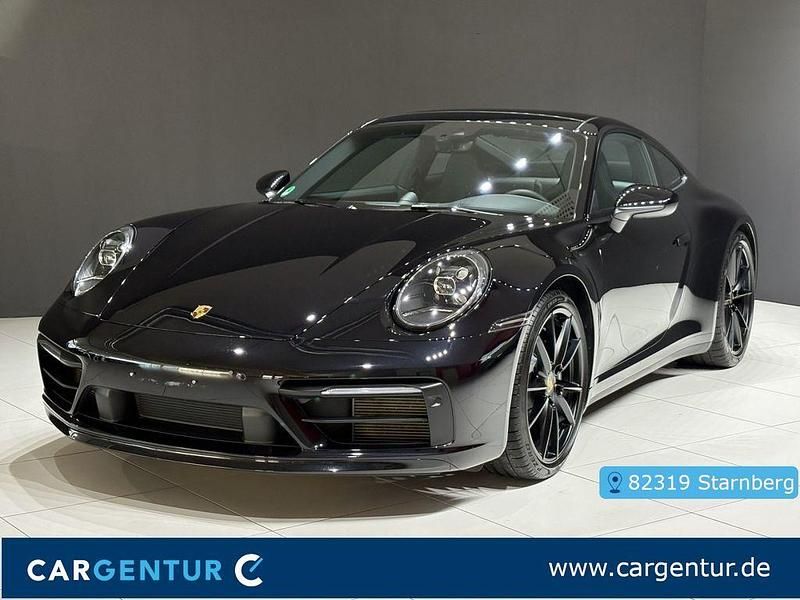 Tiefschwarz (metallic) Gebraucht 2024 Porsche 911 Carrera 4 Coupé | 134.580 € (Fairer Preis) - Bild 1/4