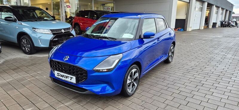 Blau Neu 2024 Suzuki Swift Comfort+ Limousine | 19.990 € - Bild 1/4